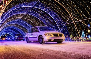 Cars passing through the tunnel at a drive thru Christmas lights show