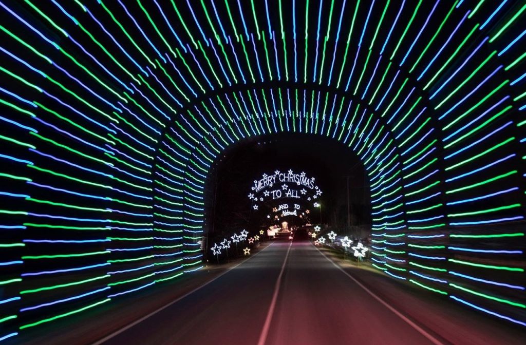 Green and blue lights surrounding a tunnel along the Tanglewood Festival Of Lights driving route