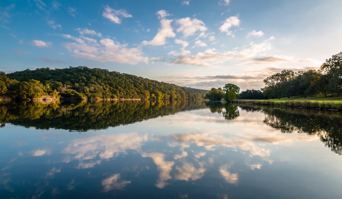 Clouds and trees reflecting in the waters of Lake Austin, one of the best lakes in Texas. Clouds and trees reflecting in the waters of Lake Austin, one of the best lakes in Texas.