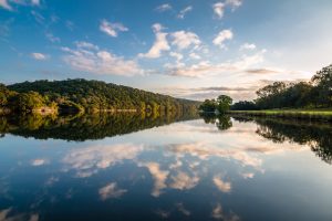 Clouds and trees reflecting in the waters of Lake Austin, one of the best lakes in Texas.