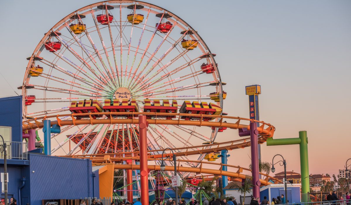 Pacific Park with ferris wheel and roller coaster during sunset A view of Pacific Park at Santa Monica Pier during sunset.