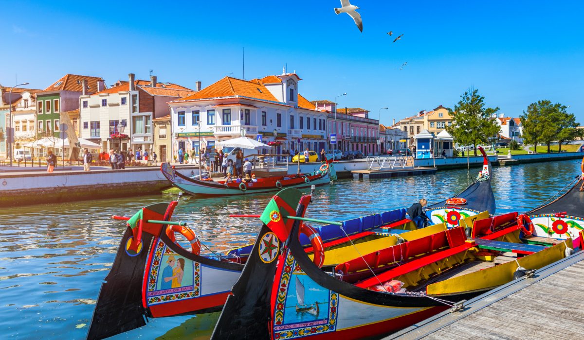 Traditional, colorful boats docked along a canal in Aveiro, Portugal