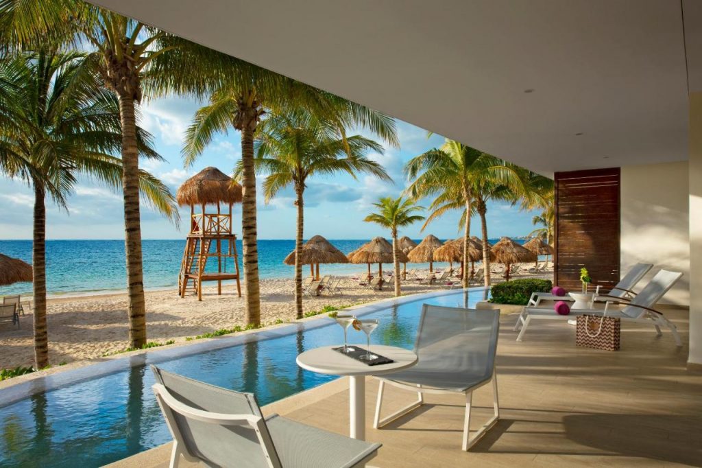 Beachside and poolside amenities of Breathless Riviera Cancun Resort.