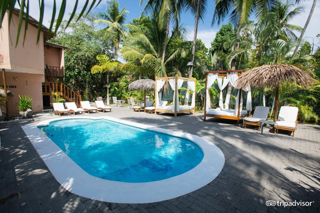 Poolside amenities of Copacabana Hotel and Suites during daytime.