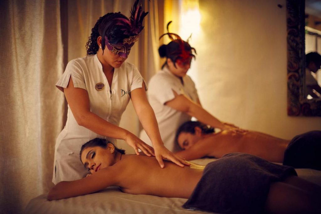 Topless man and woman getting a massage at Desire Riviera Maya Pearl Resort.