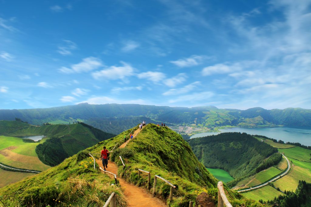 People walking along a mountain top trail in Portugal during spring. 