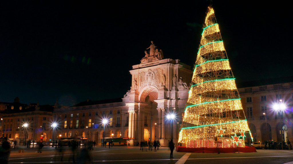 Night shot of a Christmas tree in Praca do Comercio in Lisbon during winter, the best time to visit Portugal for the budget conscious 
