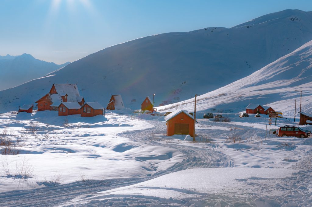 Rustic houses covered in blankets of snow in Alaska.