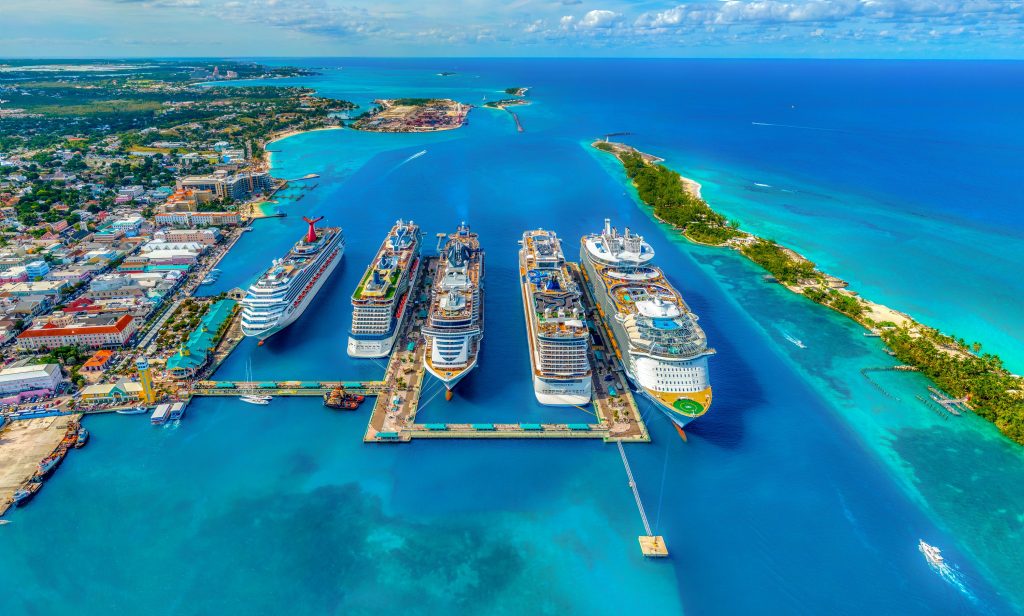 Cruise ships docked in the waters of the Bahamas, one of the best tropical places to travel without a passport.