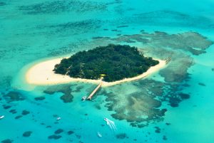 Aerial view of Managaha Island and its surrounding waters, an island of Northern Mariana Islands, one of the best places to travel without a passport.