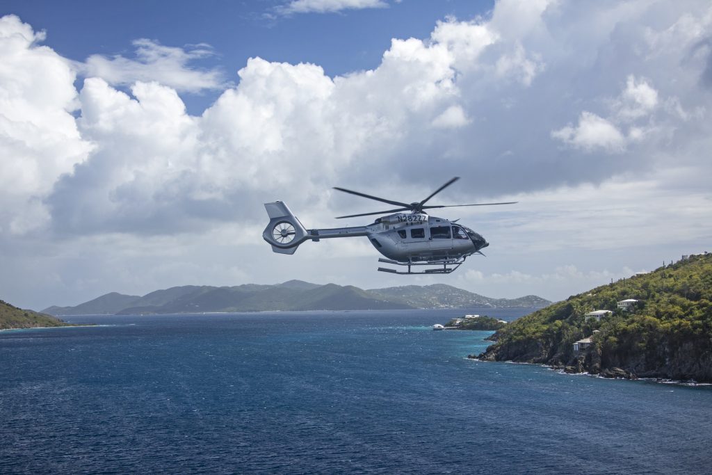 Chopper flying over the Caribbean, one of the unique things to do in St Thomas.