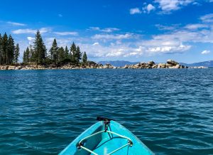 View of Sand Harbor in Lake Tahoe on a blue kayak.