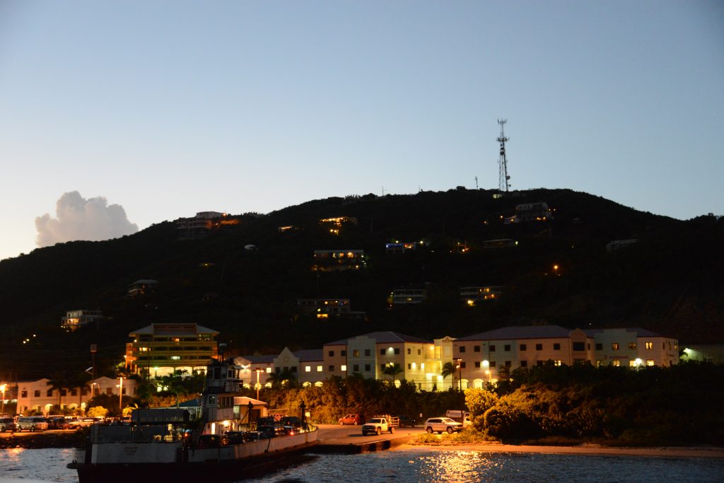 View of the restaurants and buildings in Red Hook from the water during dusk.