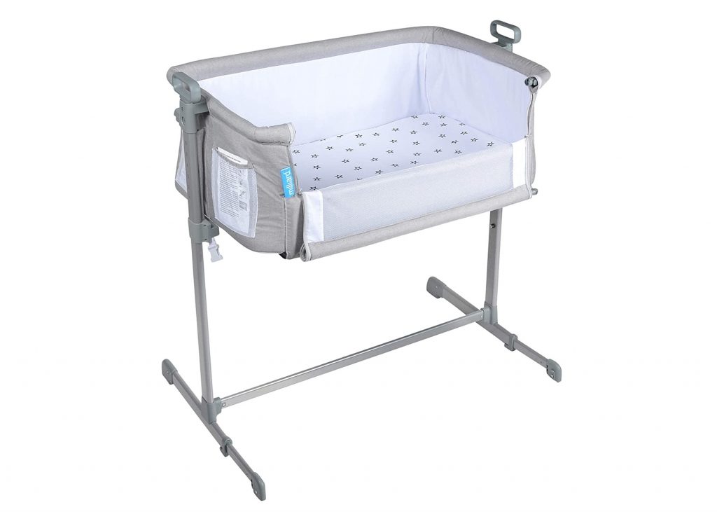 Milliard Bedside Bassinet in gray with a sidewall lowered. 