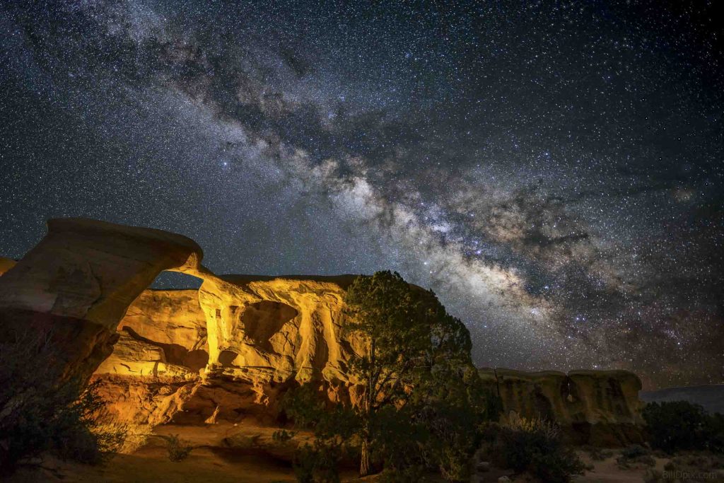 Starry night over rock formations at Arches National Park. 