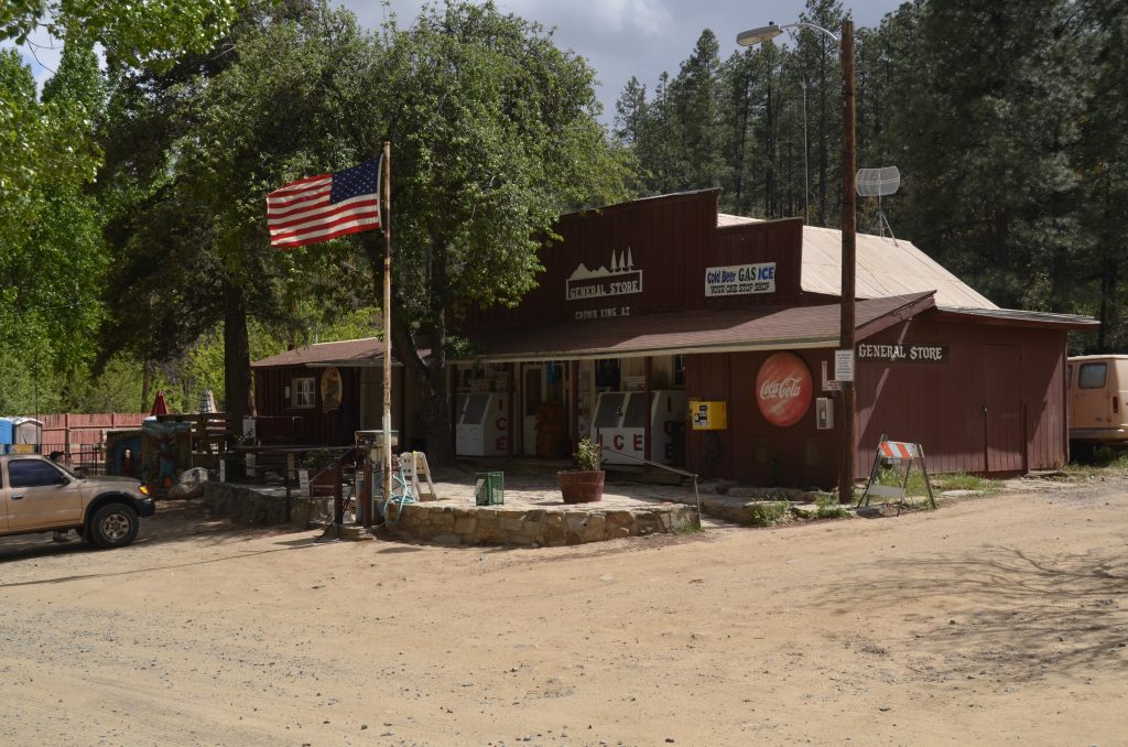 The facade of the general store at Crown King, a living ghost town in Arizona, with an American flag outside.