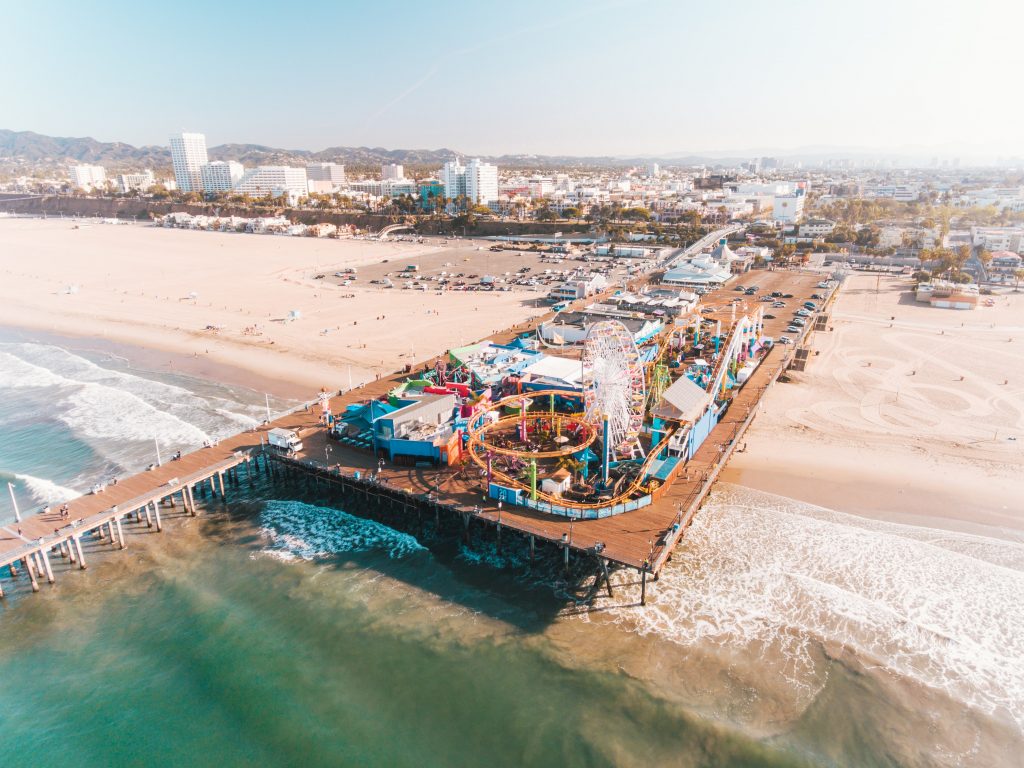 Aerial shot of Santa Monica Pier and beach in Los Angeles, one of the best places to visit in May in the USA.