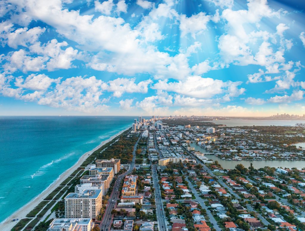 Aerial shot of the buildings and coastline of Miami Beach, one of the best places to visit in the US in May.