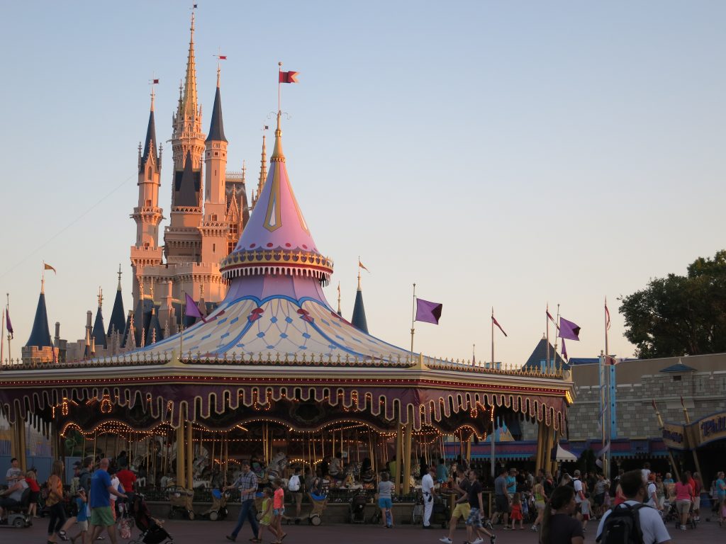 Cinderella Castle in Walt Disney World filled with crowds. 