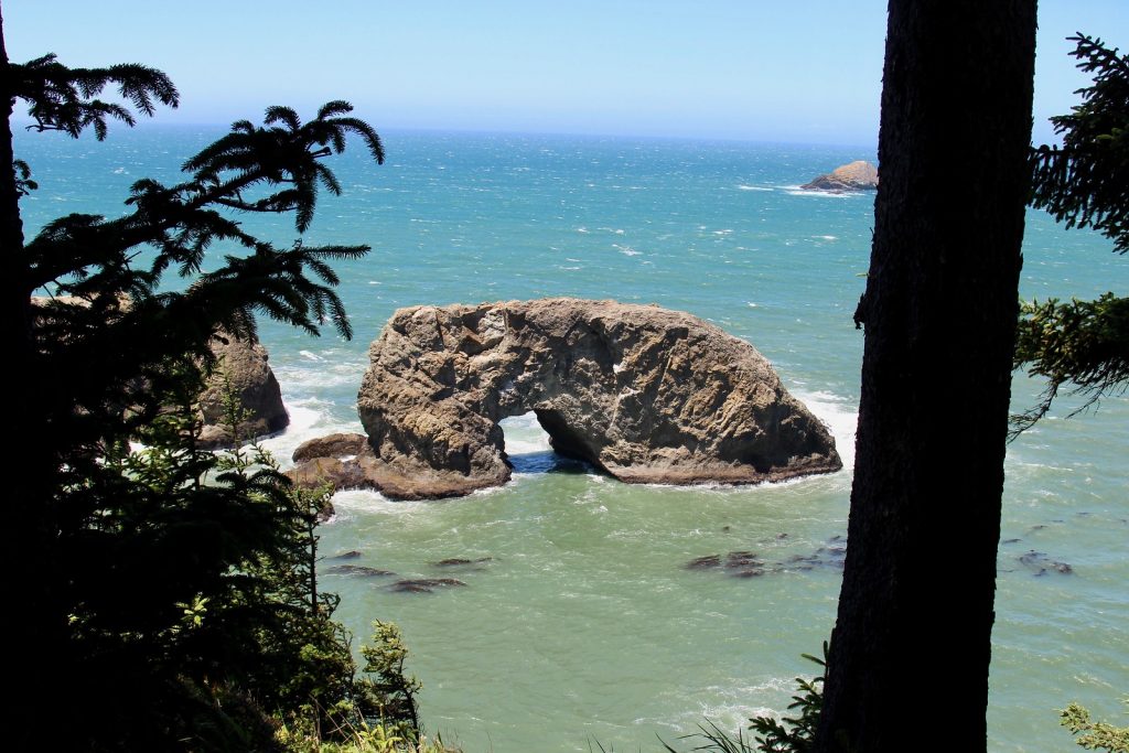 Perspective on Arch rock standing in the Pacific Ocean from the Arch Rock Viewpoint. 