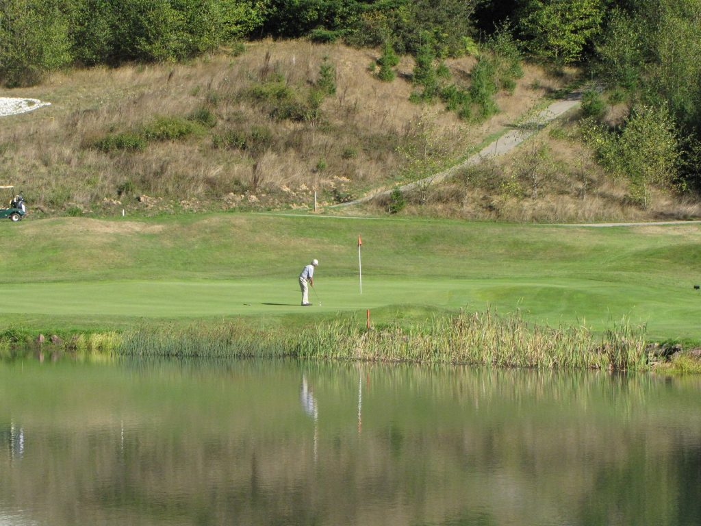 A man playing golf at the Salmon Run Golf Course.