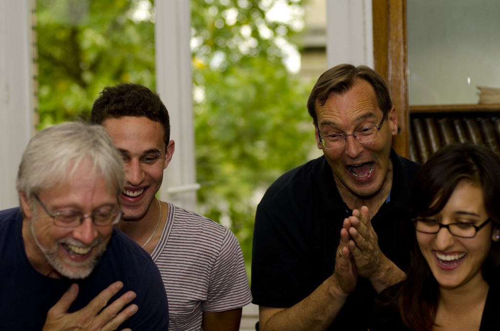 A group of people having a good time and laughing their hearts out.
