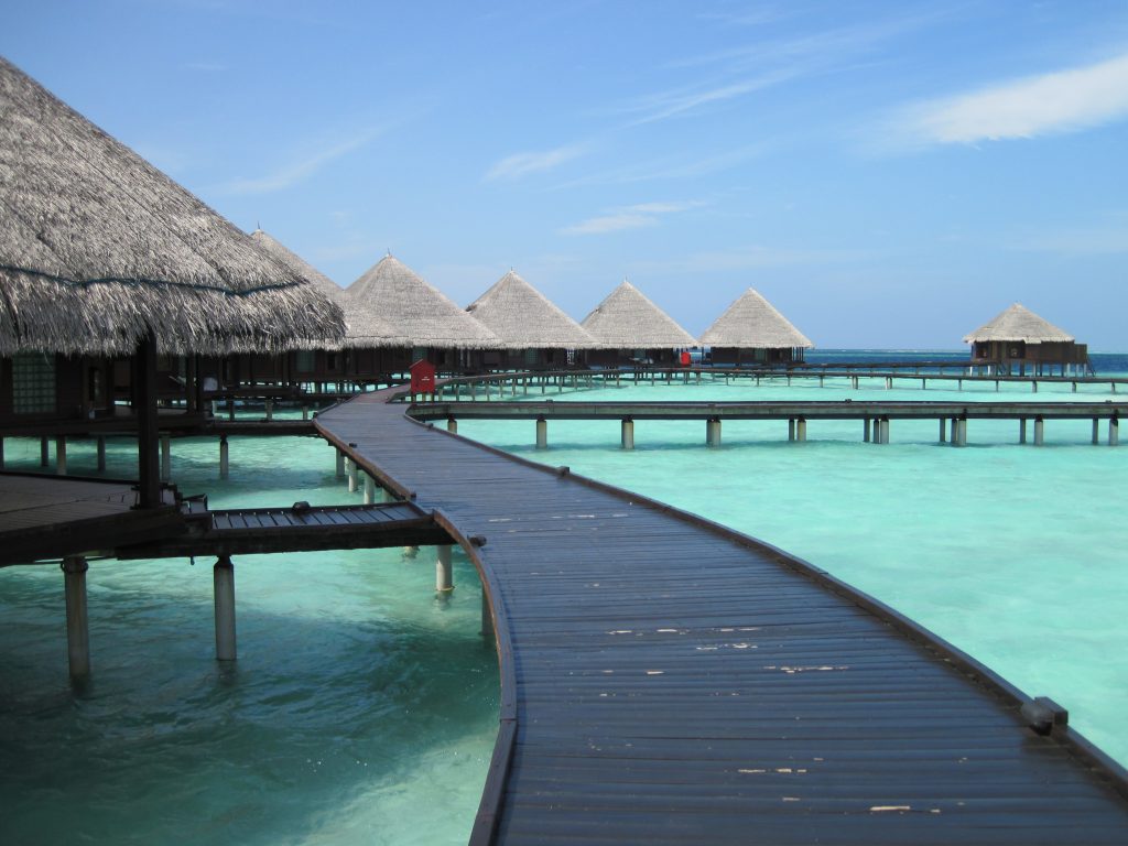Bungalows and walkway in one of the Maldives resorts during the low season; the best time to visit Maldives for budget travelers.