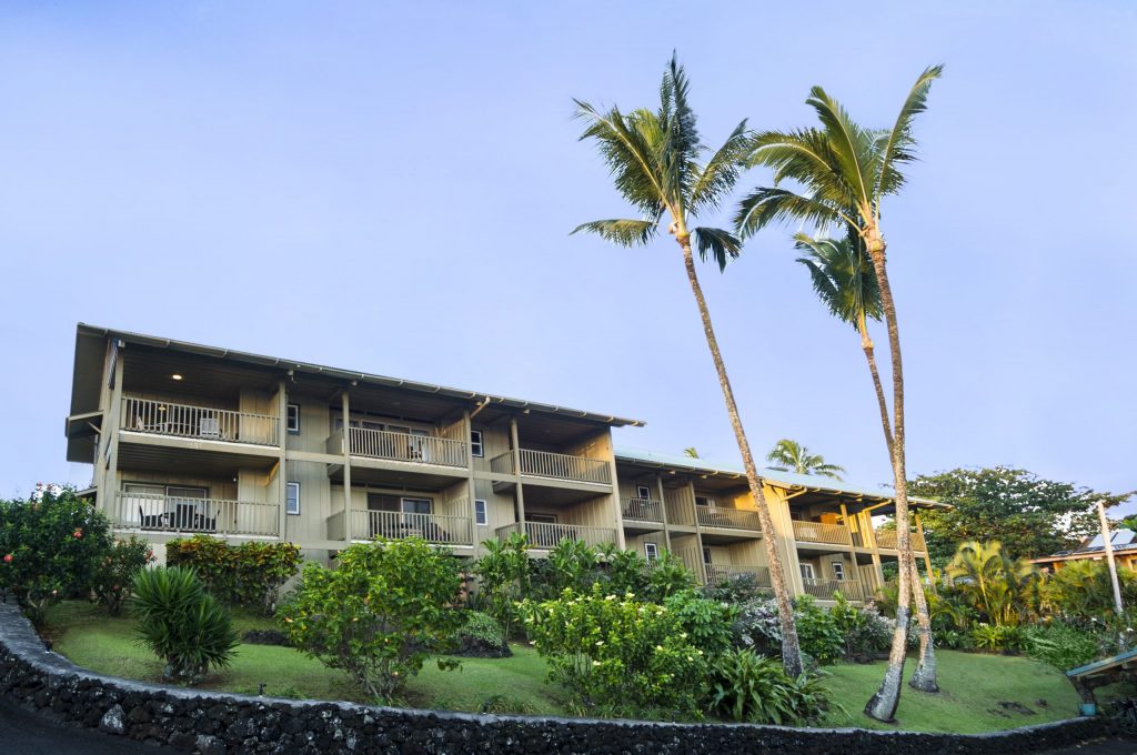 Exterior of lodging units of Hana Kai Maui with lush greenery and palm trees; where to stay in Maui for a night. Exterior of lodging units of Hana Kai Maui with lush greenery and palm trees; where to stay in Maui for a night.