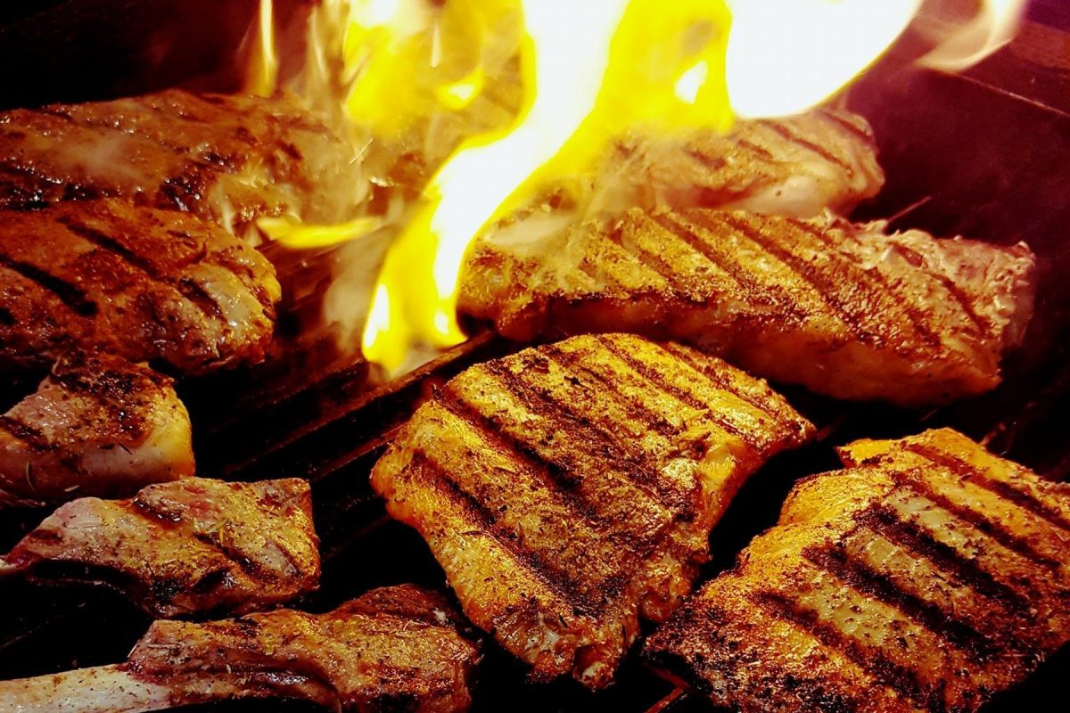 Slabs of meat on a flame grill at Apollo Restaurant, one of the Seward restaurants that serve Mediterranean-inspired dishes.