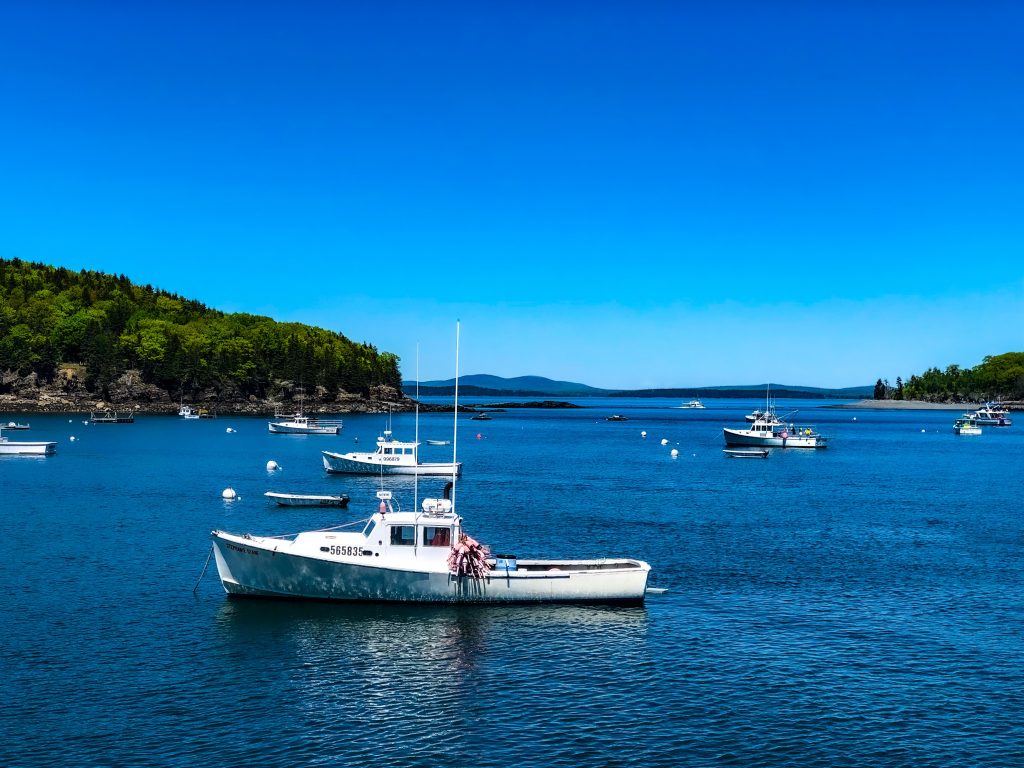Boats in the waters of Bar Harbor; one of the best places to visit in July USA.