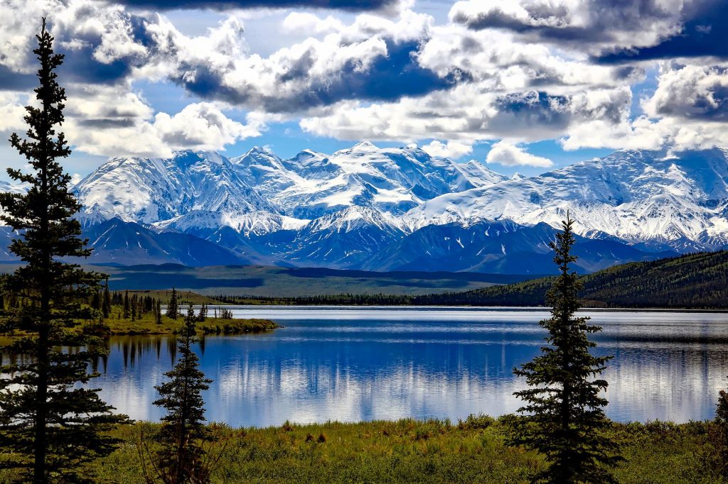 Snow-capped mountains in Denali National Park, one of the places to visit in July that are not hot.