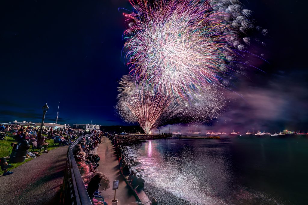 Colorful firework display in the night sky during 4th of July in Bar Harbor, Maine; one of the best places to visit in July in the USA.