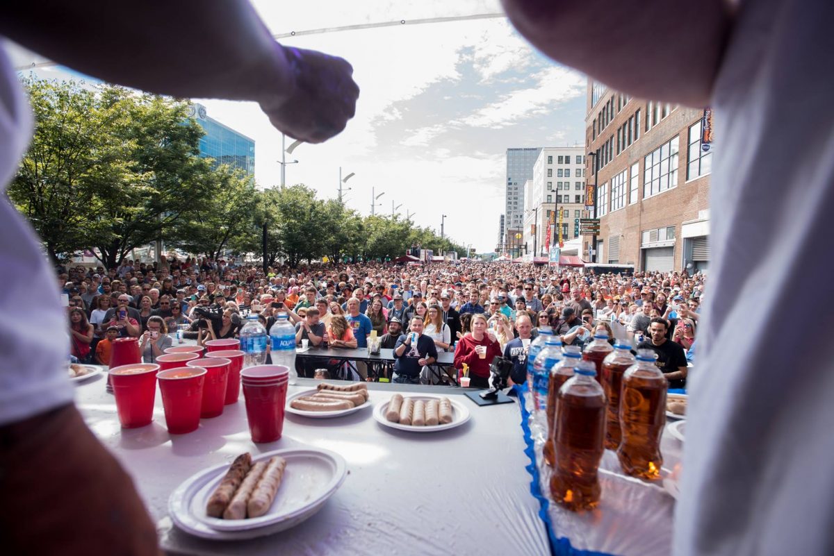 Crowd watching the eating contest during Oktoberfest Zinzinnati; Oktoberfest near me in Ohio.