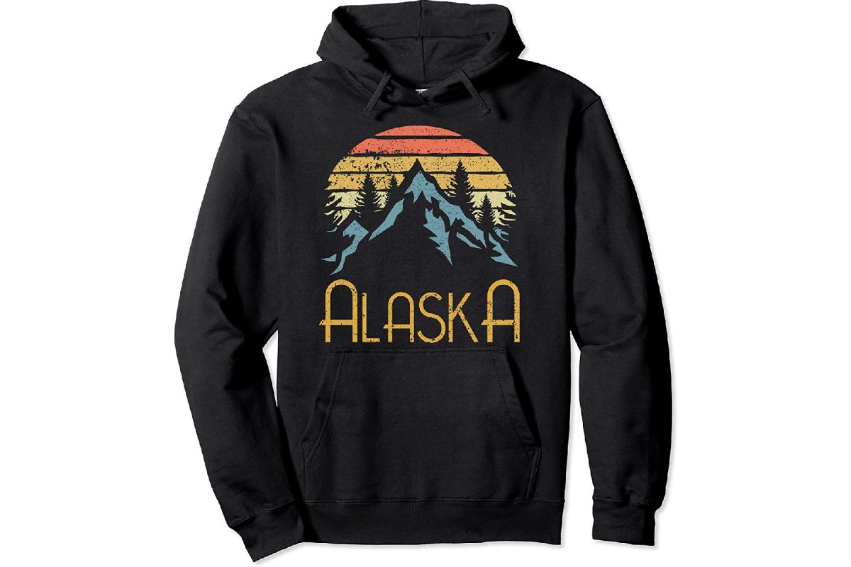 Black sweatshirt with a printed Alaska-inspired design with mountains and trees, one of the classic Alaska souvenirs. 