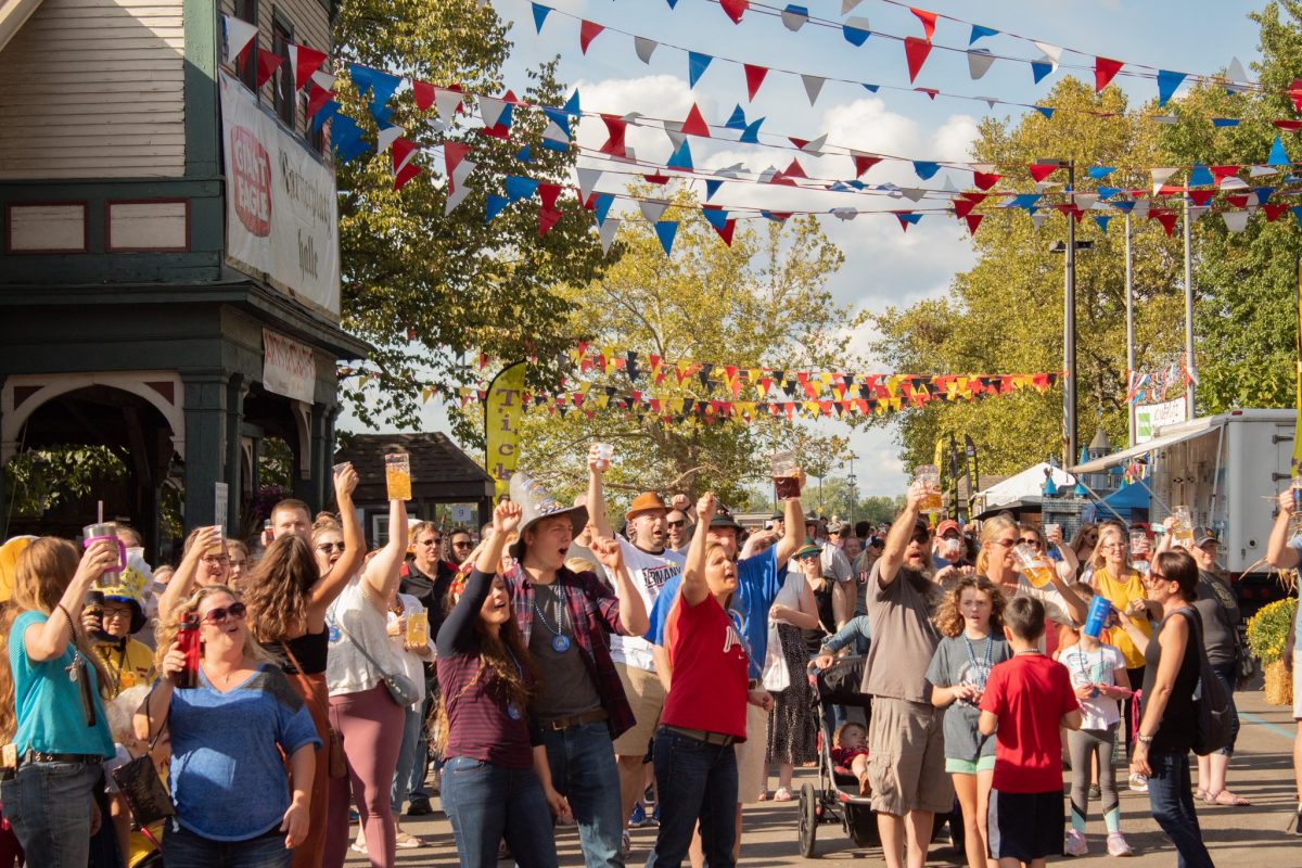 Crowd raising beer glasses during Columbus Oktoberfest; Oktoberfest near me in Ohio.