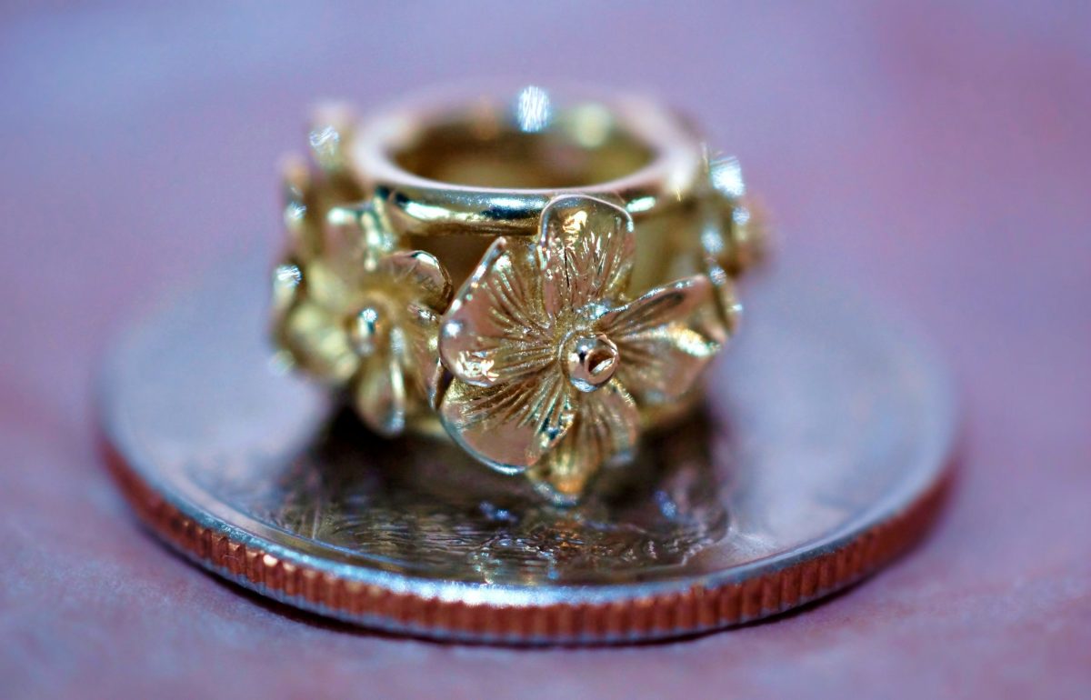 Gold jewelry with flowers engraved on the outside, one of the best souvenirs from Alaska.