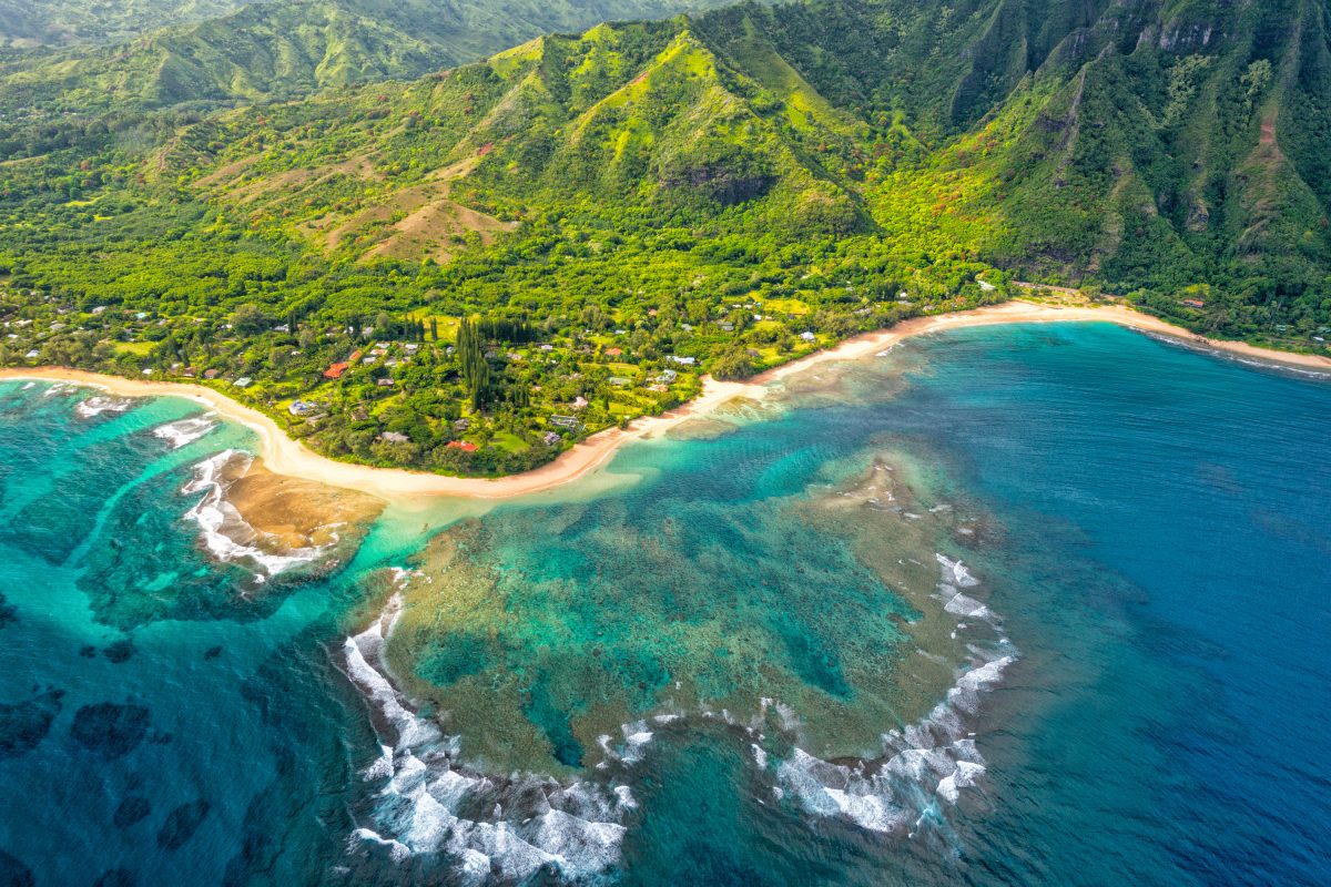 Aerial shot of the coast of Kauai, Hawaii, one of the best fall vacation spots in the US.