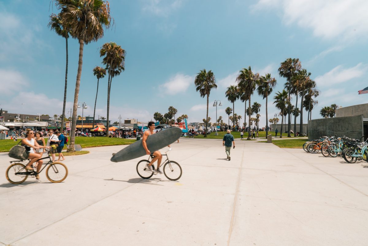 People biking and walking around Venice Beach in Los Angeles, one of the best places to visit in September in the USA.