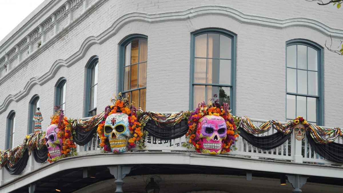Painted skeleton masks and other Halloween themed decorations displayed on the balcony of one of the buildings in New Orleans during October.