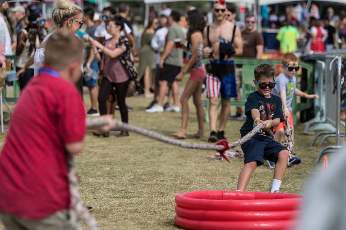 Children playing tug of war during Oktoberfest Tampa; Oktoberfest near me in Florida.