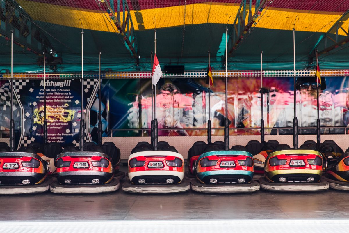 A row of bumper cars at a state fair, 15 fun things to do in the fall.
