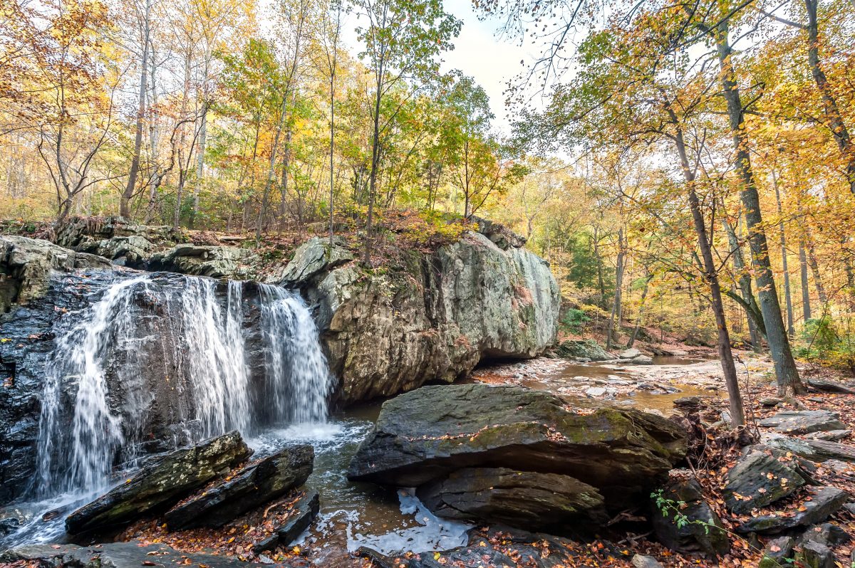 Kilgore Falls in Rocks State Park, Maryland, surrounded by autumn colors.
