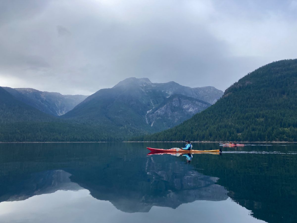 Kayaker on Ross Lake at North Cascades National Park, Washington.