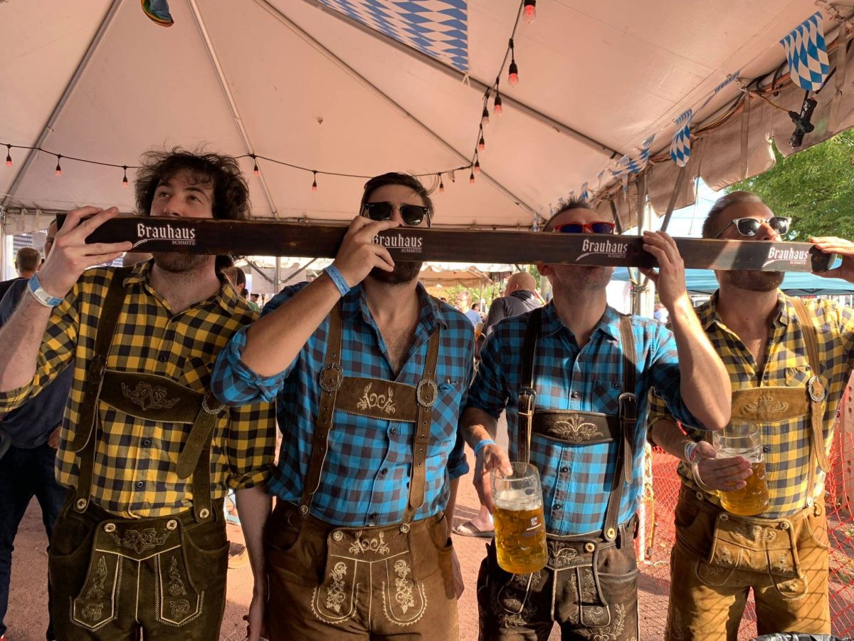 Men competing in one of the drinking games during Street Armory Oktoberfest; an Oktoberfest near me in Philadelphia.