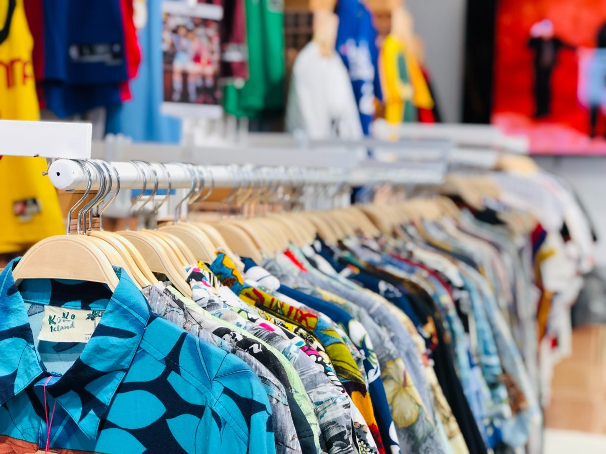 rack of hawaiian shirts in different colors and patterns on sale in a store.