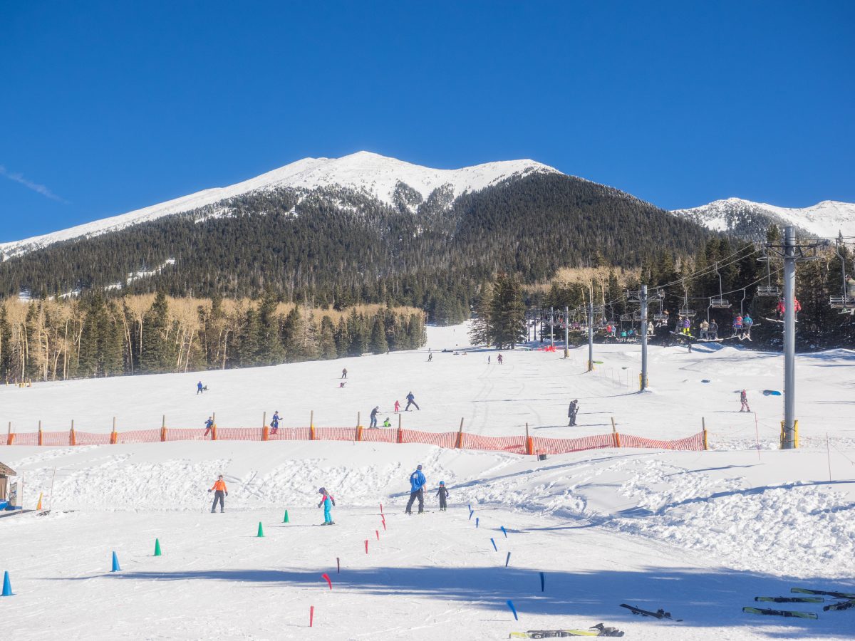People skiing at Arizona Snowbowl, one of the top things to do in Flagstaff during winter.