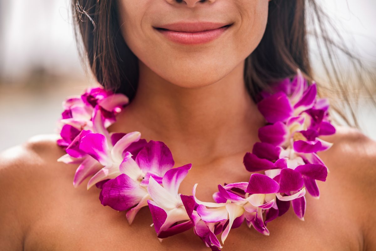close-up shot of a woman wearing a flower lei, one of the best hawaii souvenirs.