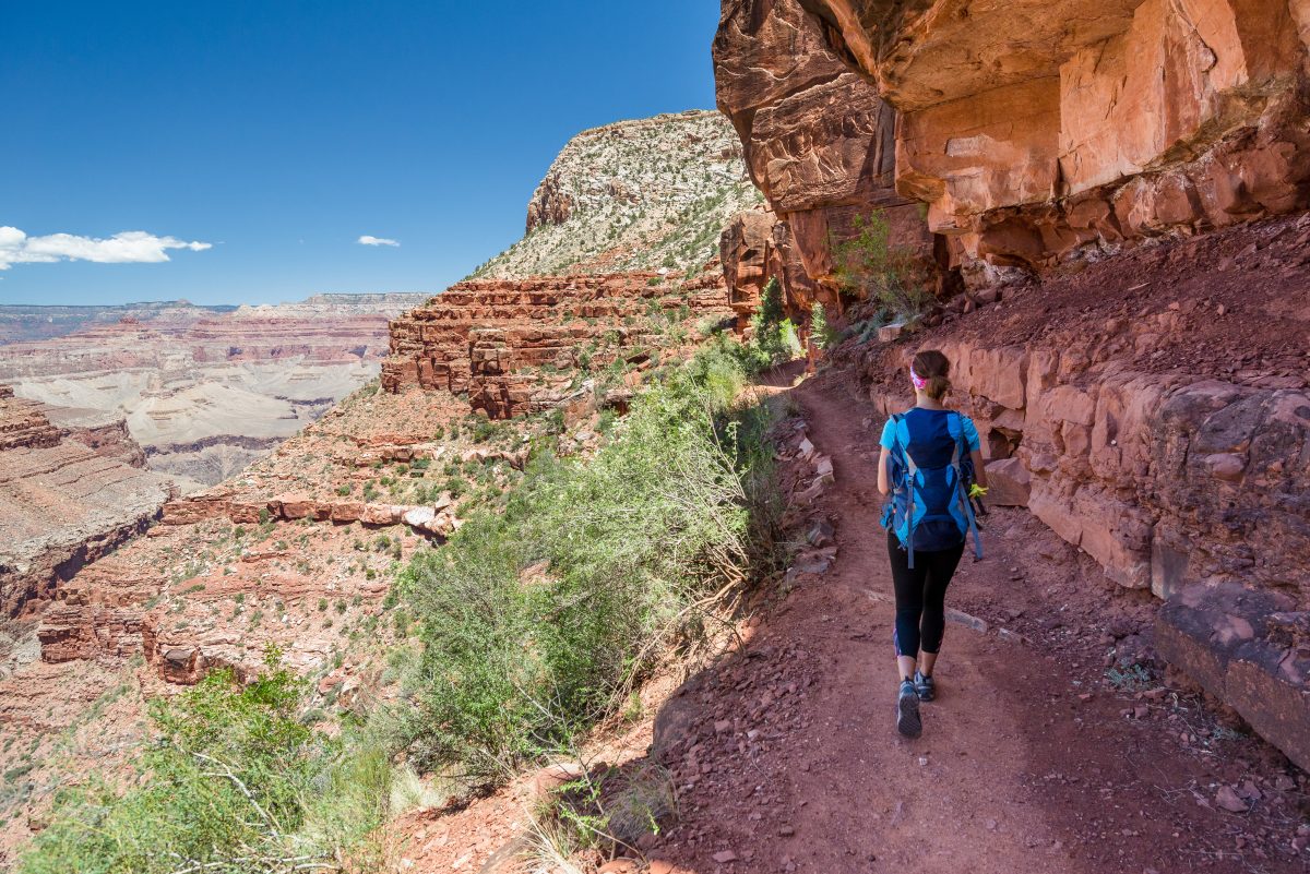 Woman hiking along the trails of Grand Canyon National Park, one of the best things to do near Flagstaff.