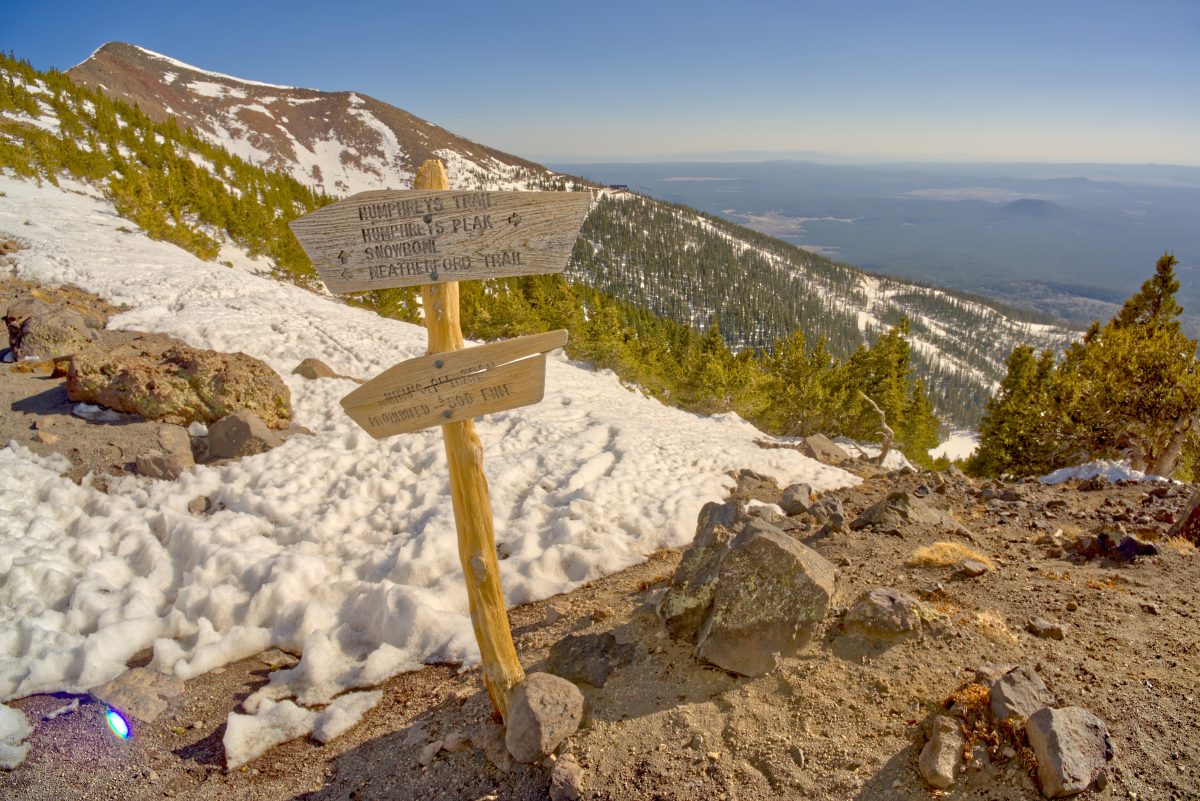 Hiking trail sign of Humphreys Peak during winter.