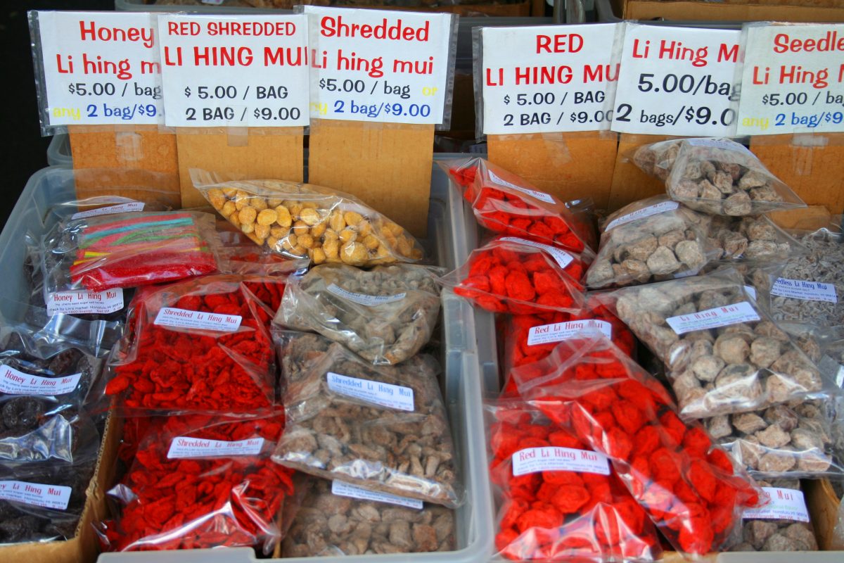 packs of different flavored li hing mui at a swap meet in hawaii.